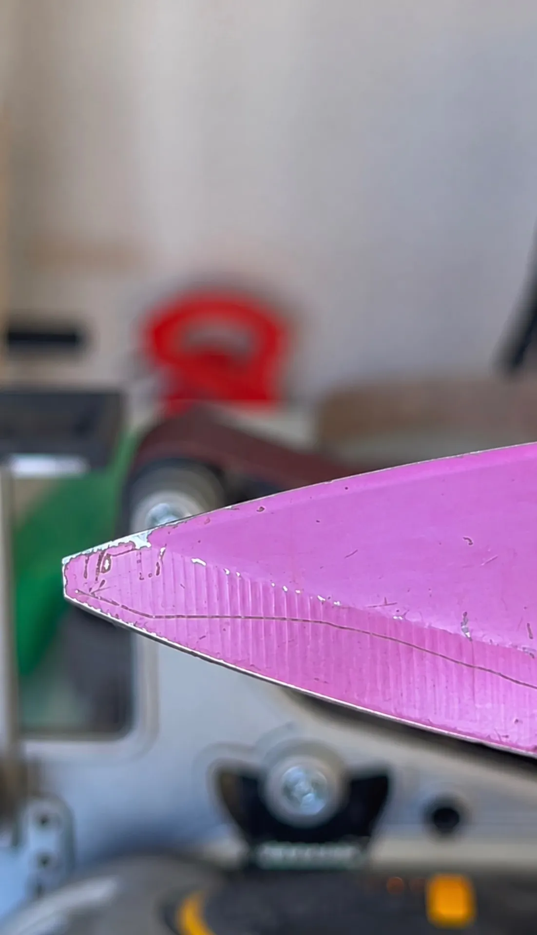 Close-up of a chipped pink knife edge before repair